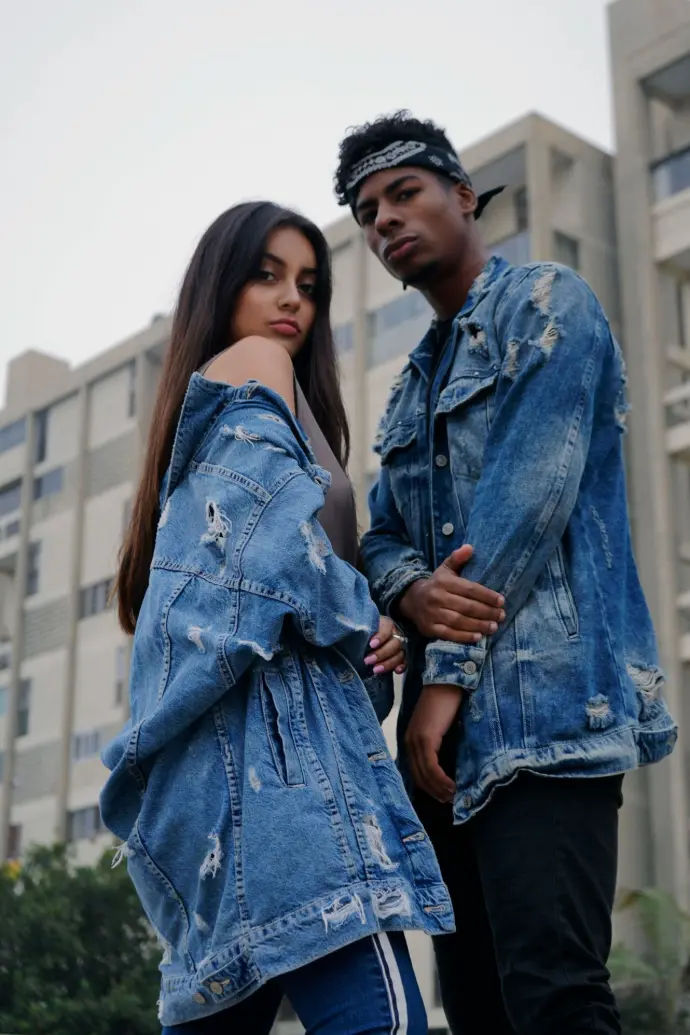 couple wearing distress denim jackets